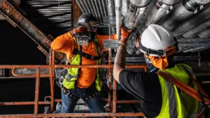 Two workers at a construction site