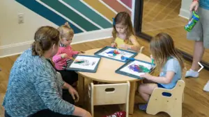 A group of kids surrounding a table at The Barn