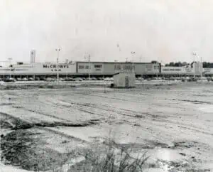 black and white photo of central plaza featuring stores like mccrory's, kinney shoes, belk-lindsey, and more