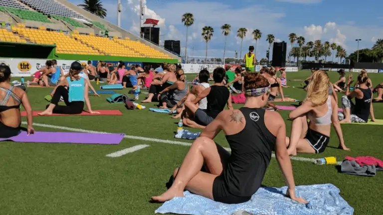 People doing yoga on the Rowdies soccer field