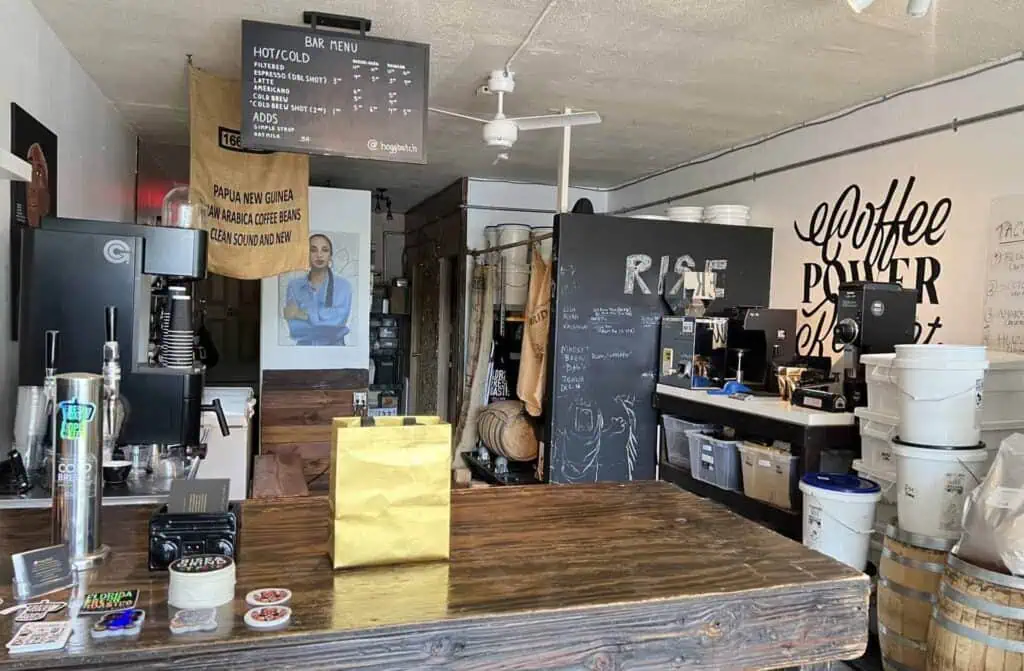 inside a coffee Roastery with a cafe counter and a menu board over the counter