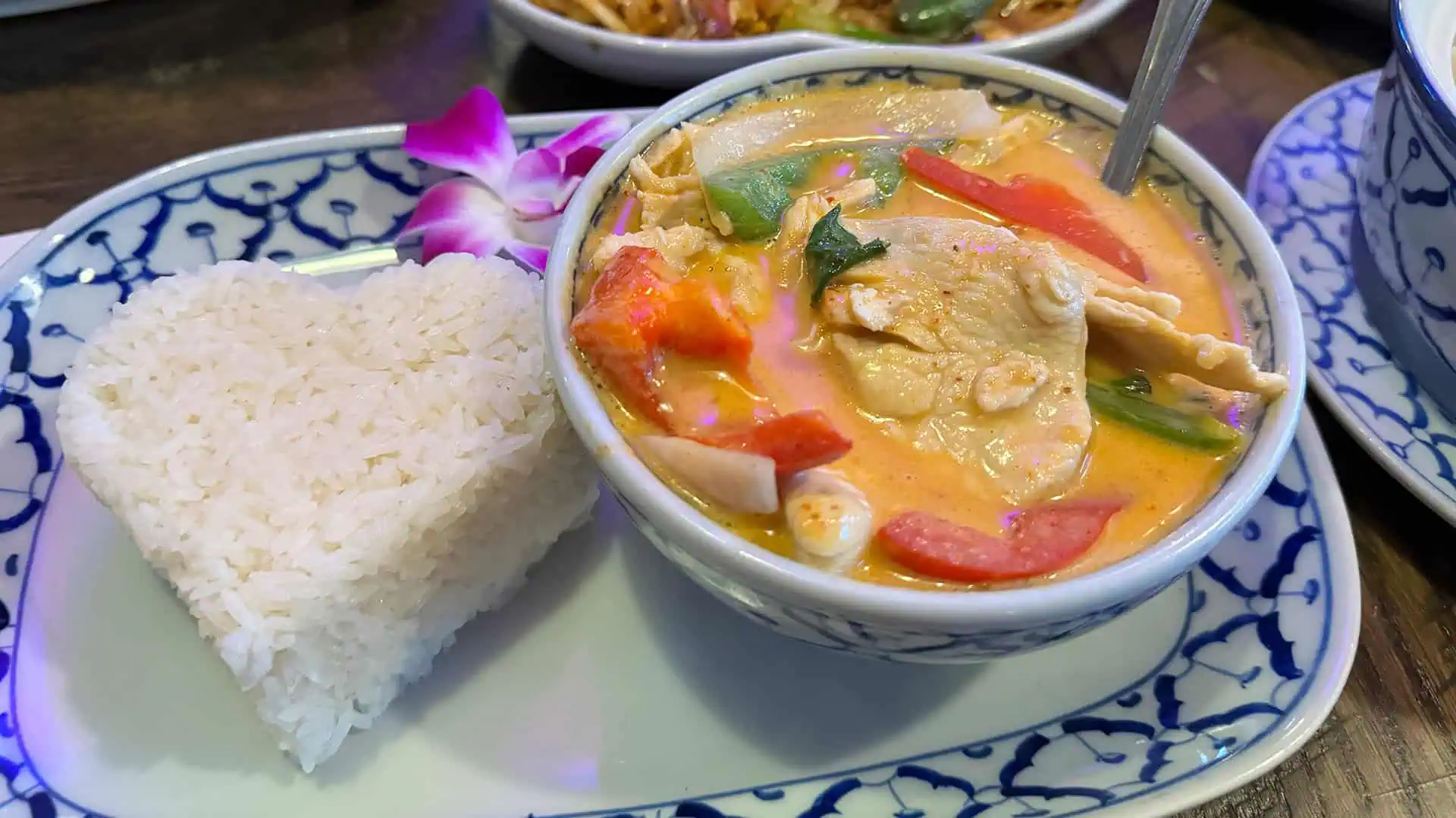 rice shaped into a heart next to a bowl of panang curry