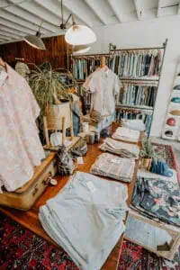 Table of clothes in store featuring men's shorts, polos and hats