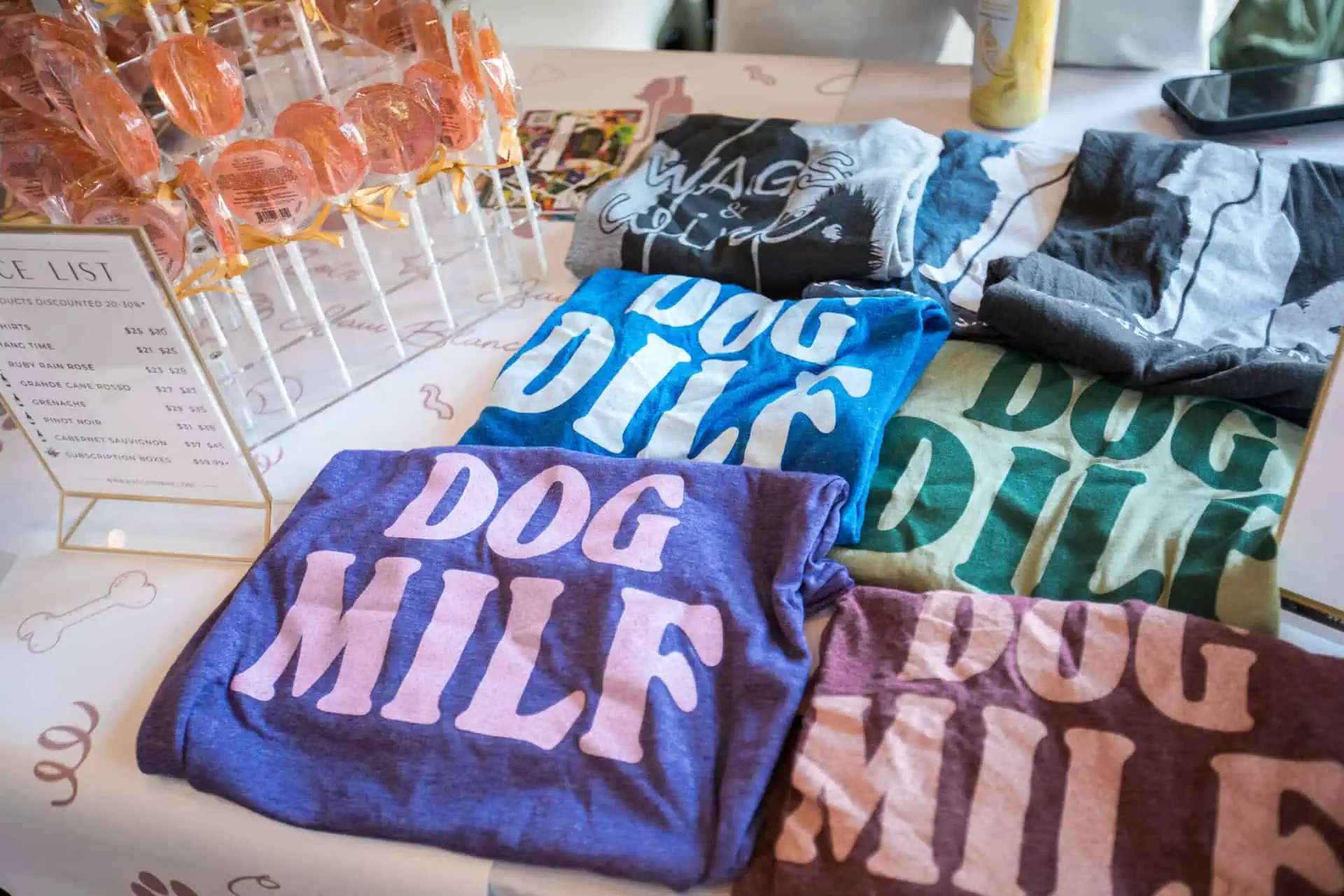 a stack of dog mom and dog dad shirts