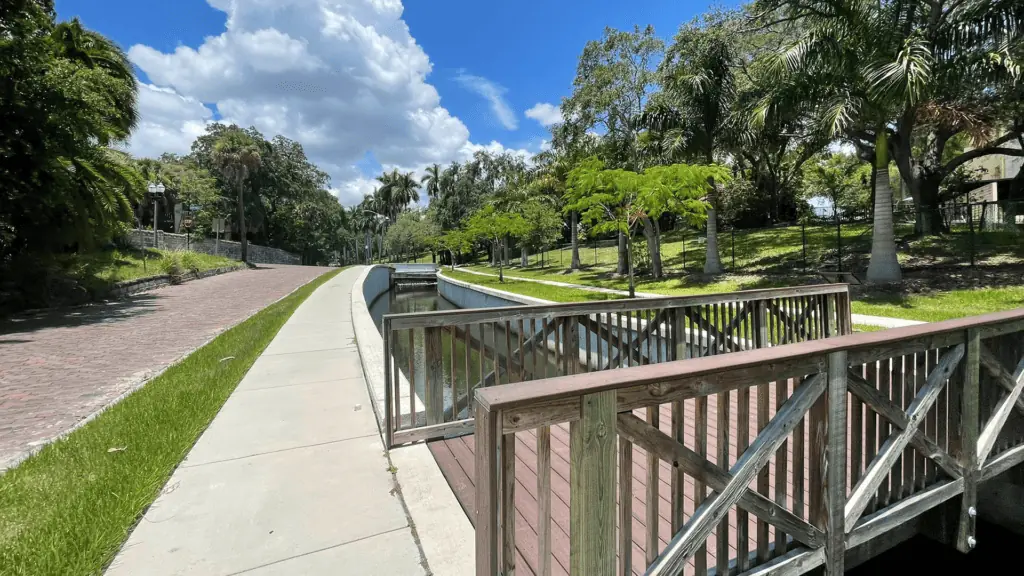 a walk way and a small bridge over a creek. 