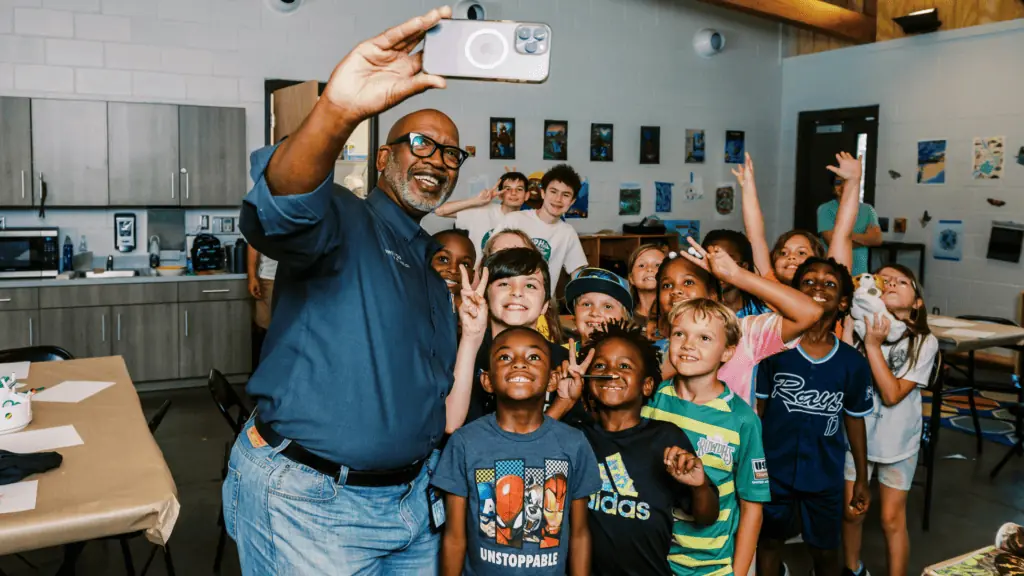Ken Welch posing for a picture with students