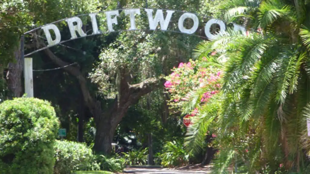 the driftwood neighborhood sign surrounded by green foliage