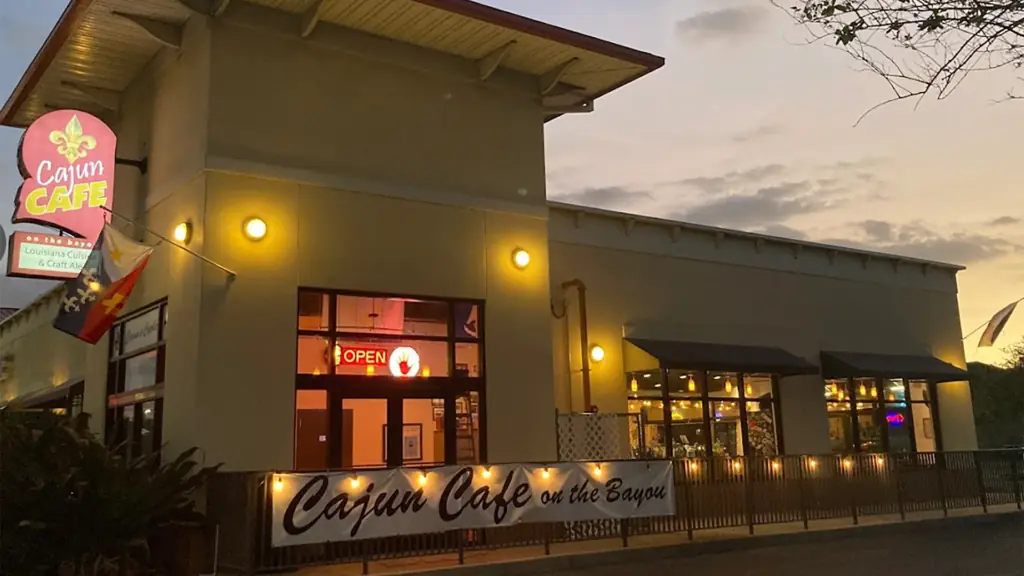 exterior of a restaurant with a red sign that reads "Cajun Cafe" on the front