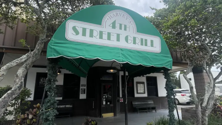 exterior of a restaurant with a green awning