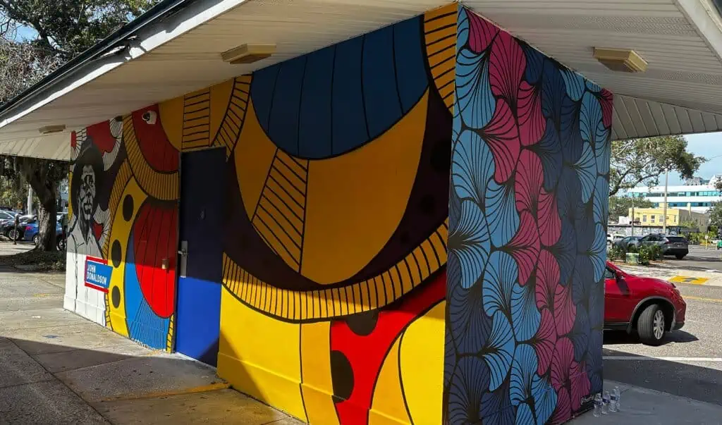 A vibrant mural painted around a ticket office at a park