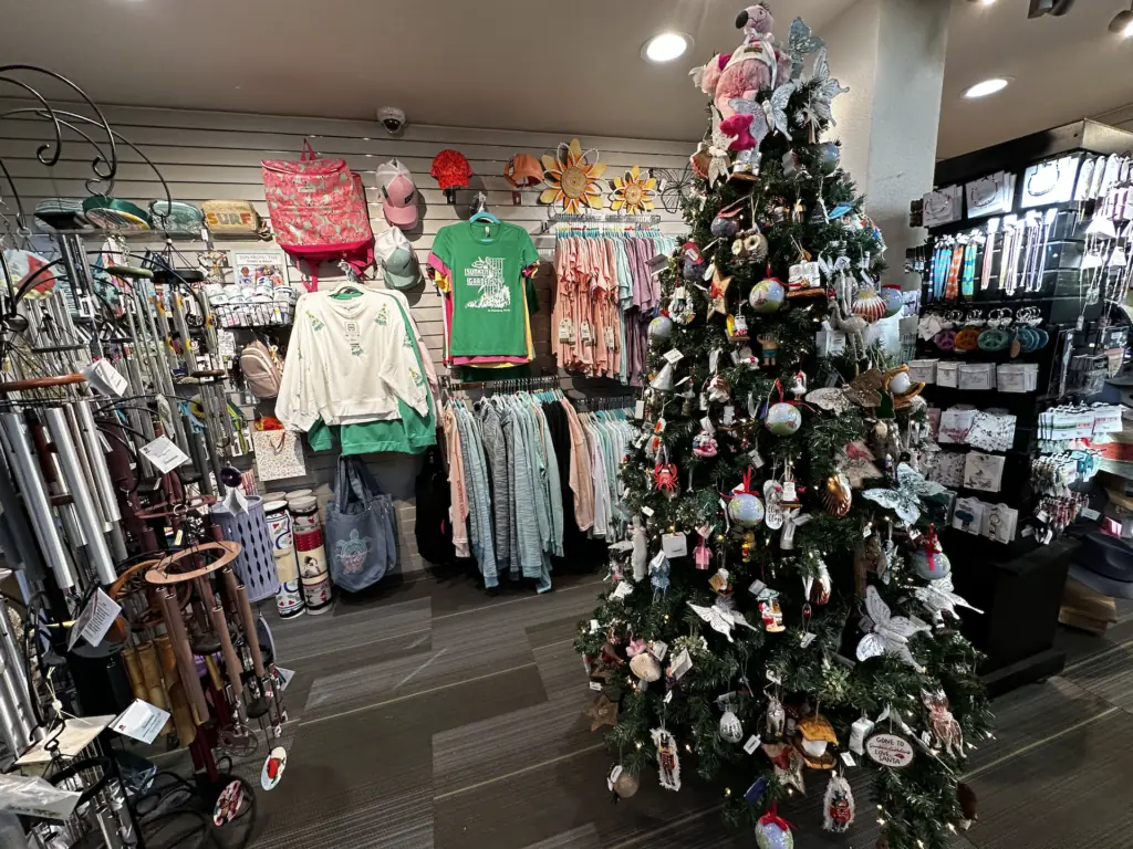 a gift shop with a decorated Christmas tree at its center
