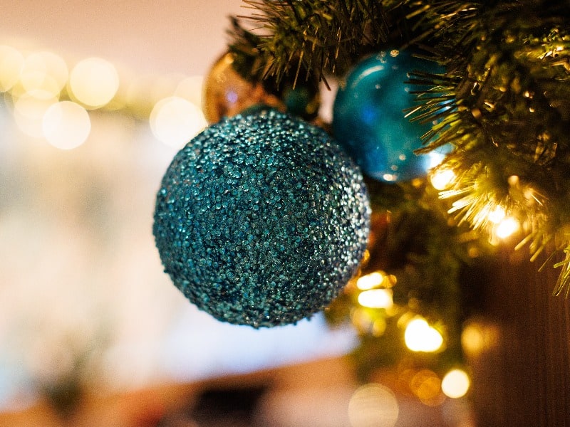 blue sparkly ornament on a Christmas Tree