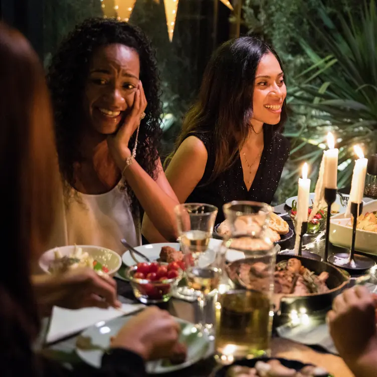 People enjoying candle lit dinner