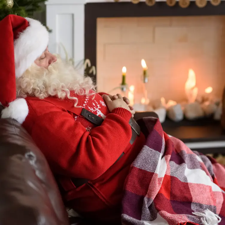 Santa sleeping by the fire