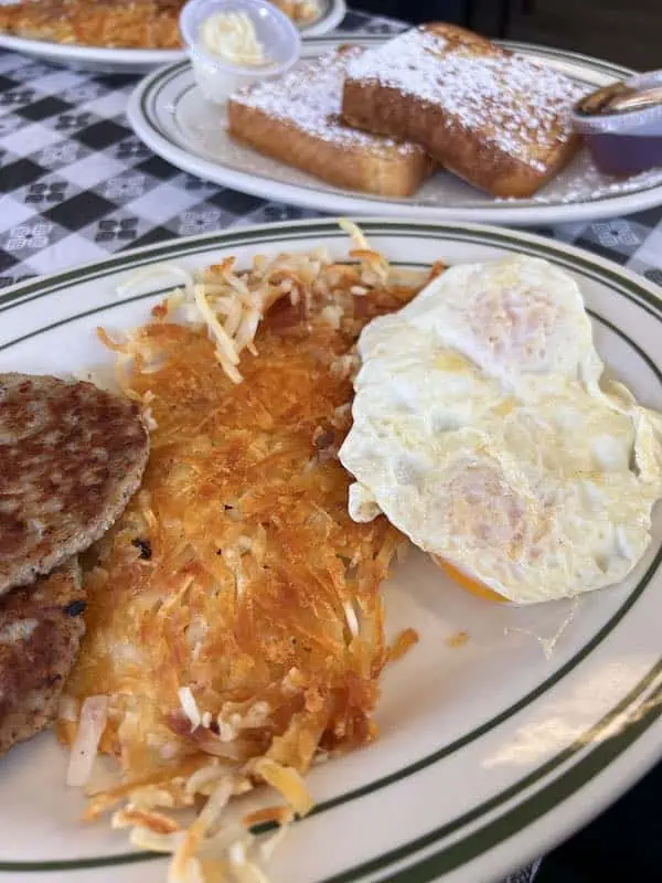 Hash browns, sausage, two eggs over easy and french toast from the Breakfast Palace