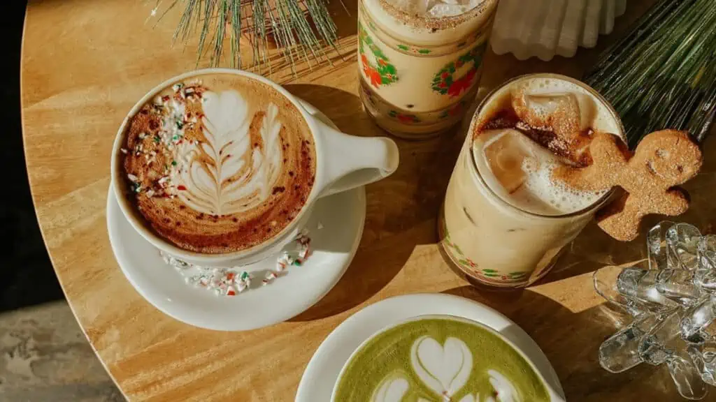 four festive drinks sit on a wooden table