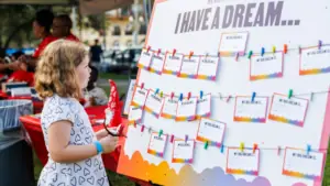 A child standing next to an art project