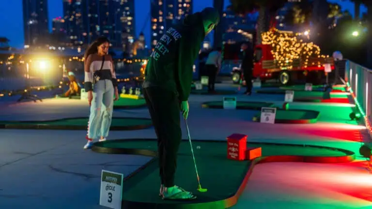 People playing mini golf