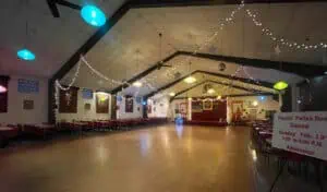 inside a ballroom with string lights hanging from the ceiling