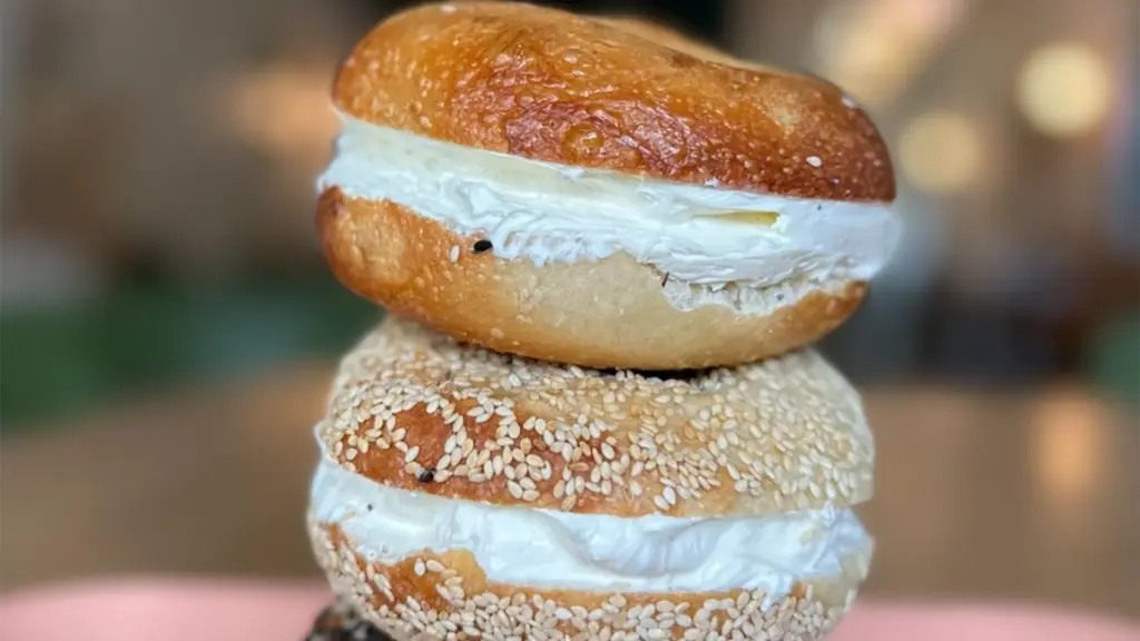 Two bagels with cream cheese stacked