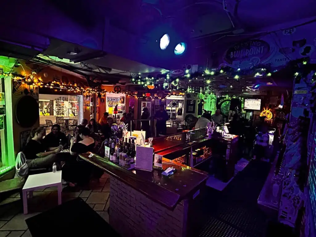 inside a bar with glowing green lights on the ceiling