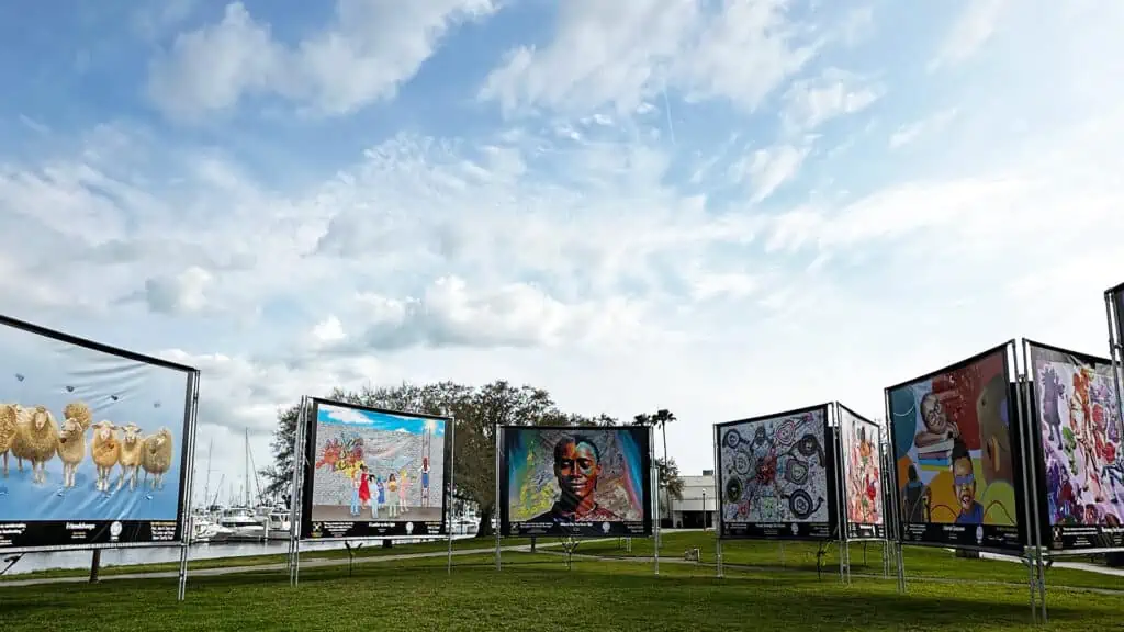 5 different banners arranged as part of an art exhibit in a park