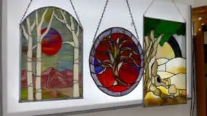 nature inspired tree stained glass art hangs on a lightbox