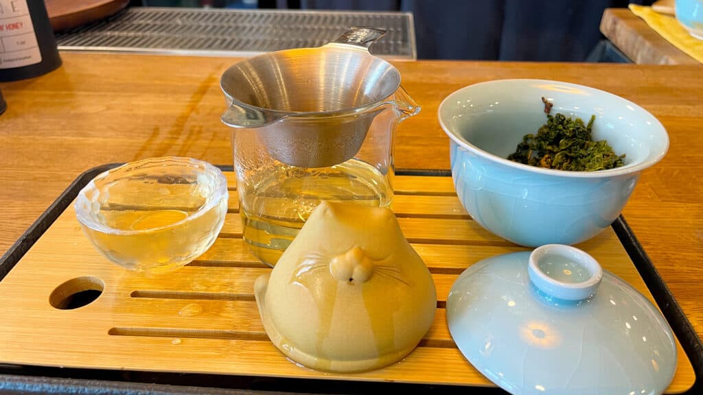 A Gongfu Cha tea board with tea pet, Gai wan, tea pot, and cup