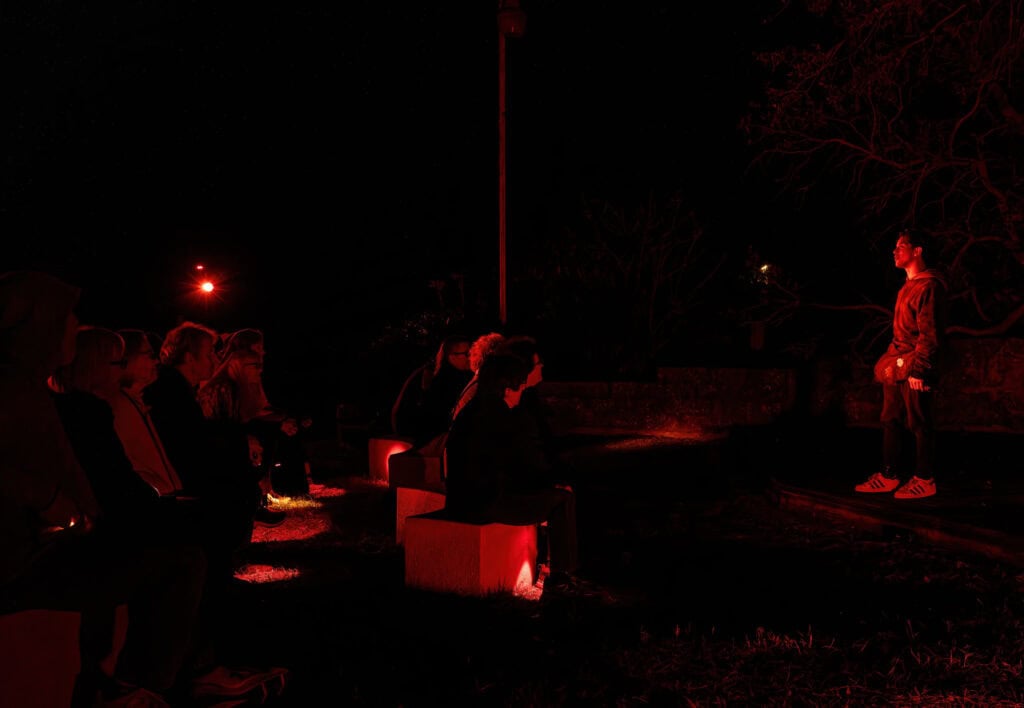 People at an outdoor stage performance