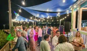 people gathered on a patio under string lights