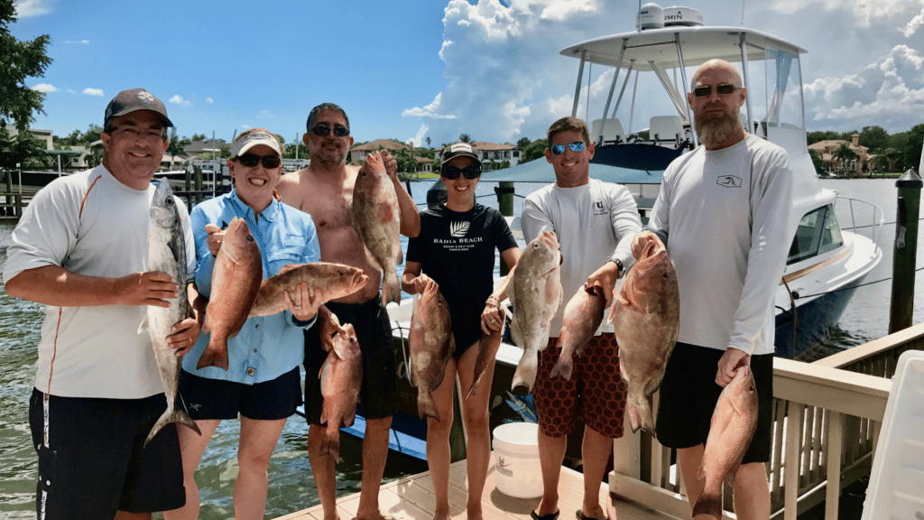 People showcasing their fish