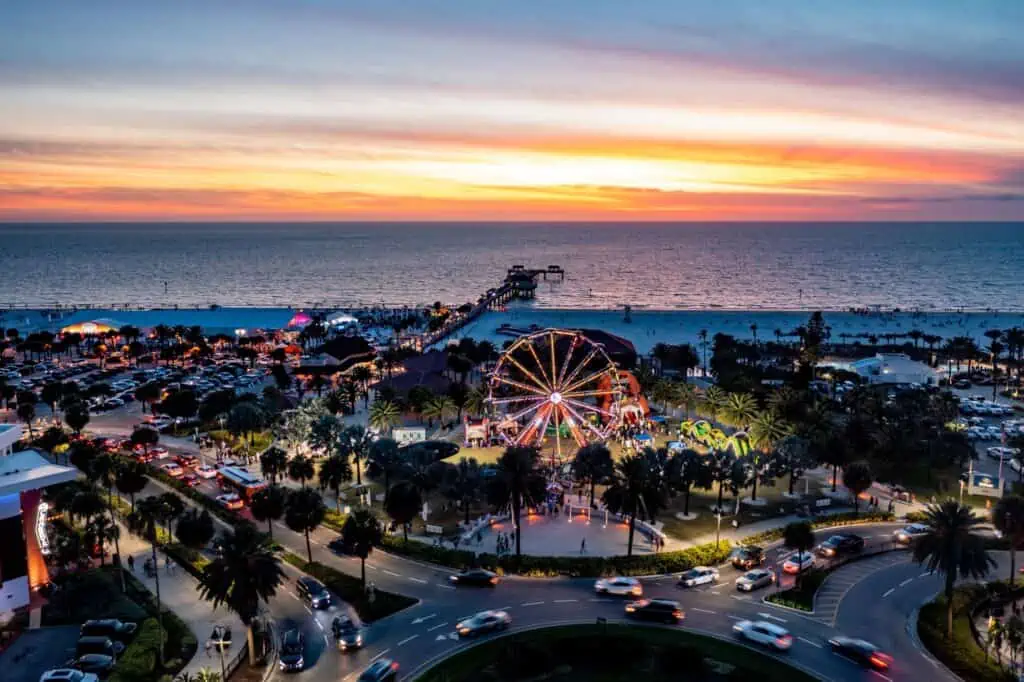 Sunset over beach view with ferris wheel 