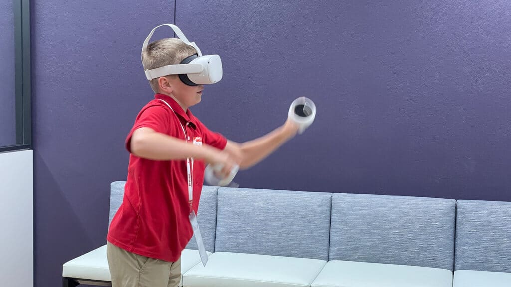a student using virtual reality headset and controllers