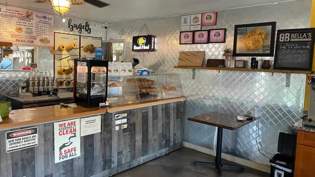 interior of a bagel cafe with pastries shown in a glass case