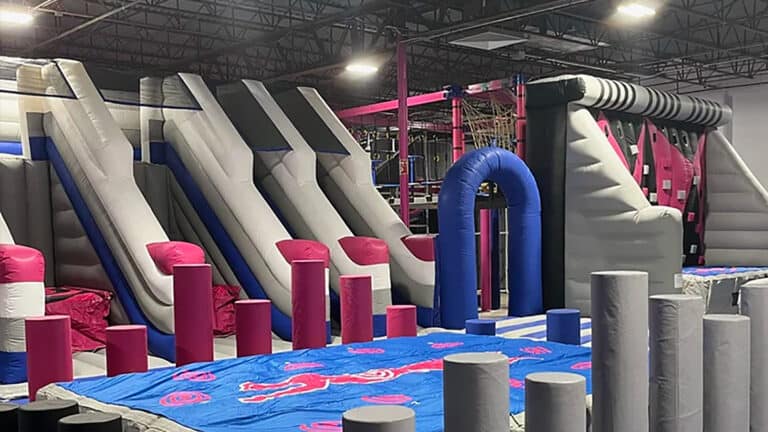 inflatable obstacle course with multiple columns arranged around a central blue ring