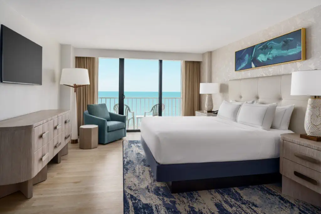 Newly remodeled rooms at DoubleTree North Redington beach. A king bed with tv, earth tones and view of the Gulf