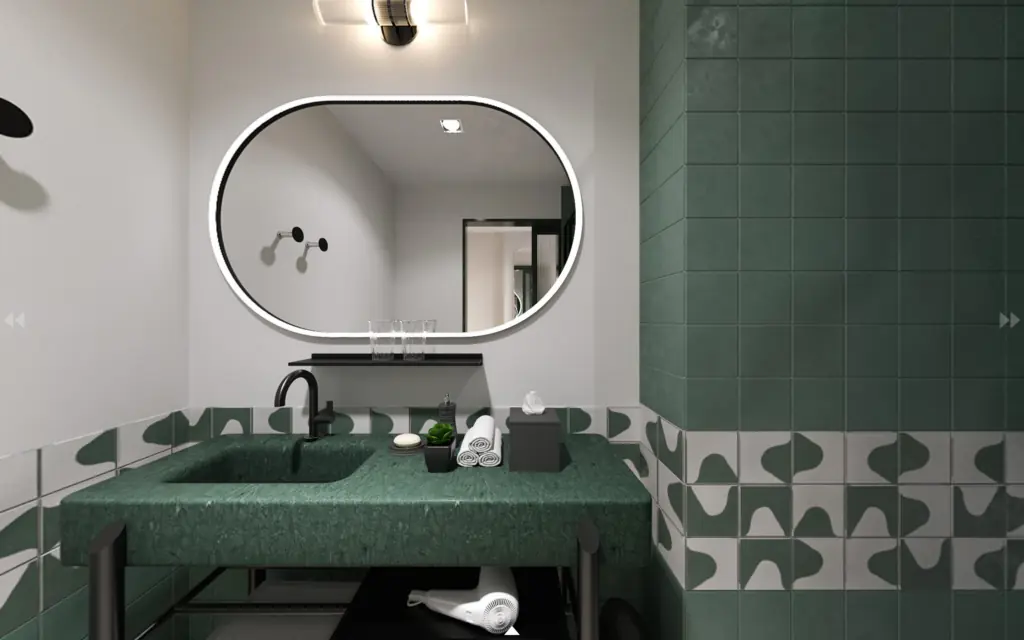 A rendering of a stylish bathroom in a king room with mirror, green tiles and green sink.