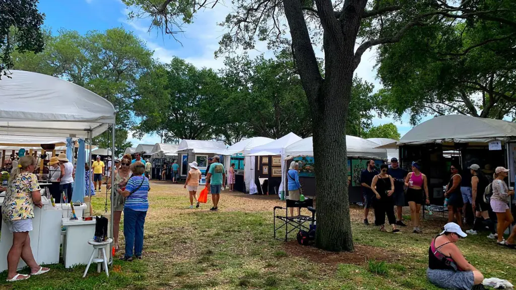 An art event in the park with multiple vendor tents set up