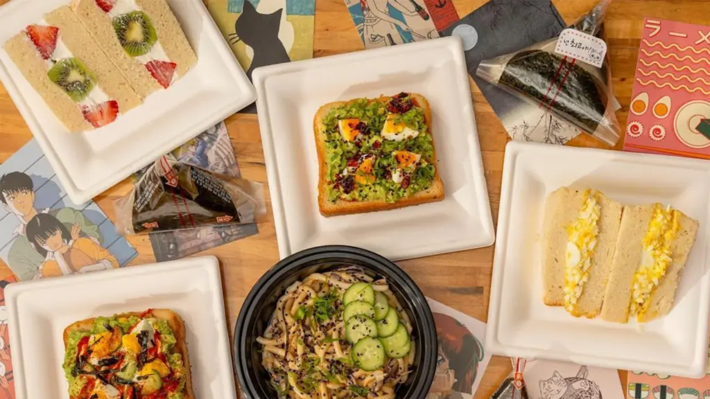 Aerial view of food on table with avocado toast, fruit sandwiches, noodle bowls and more