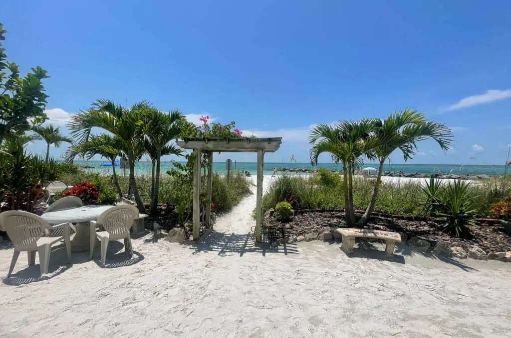 a wooden archway leading to the ocean