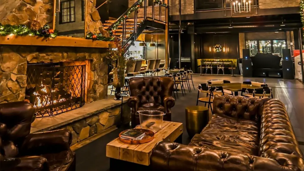 interior of a cozy bar with rustic features and lush leather couches