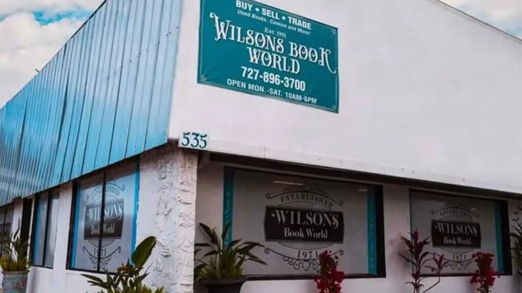 Wilson's storefront with sign on roof and window saying Wilson's Book World