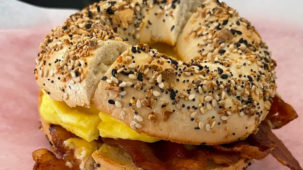 a classic bacon egg and cheese bagel with everything seasoning on top