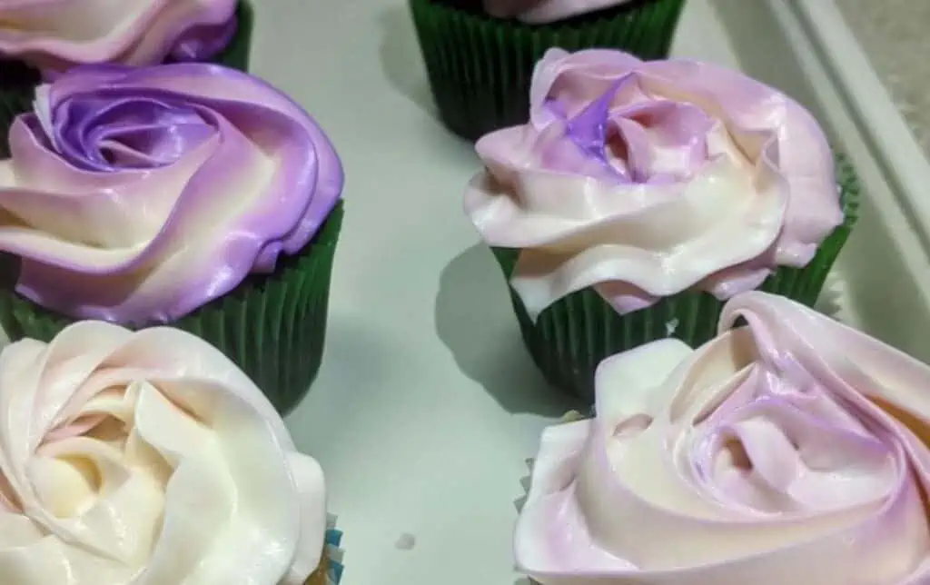 cupcakes with purple swirled frosting on top