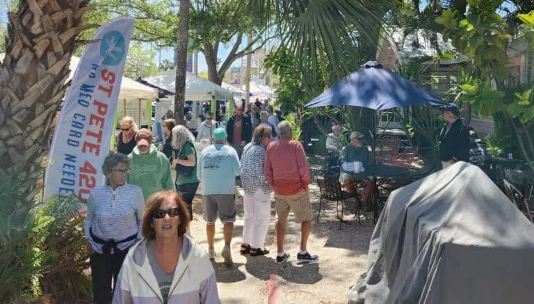Patrons peruse the main thoroughfare of Gulfport while a farmers market is set up