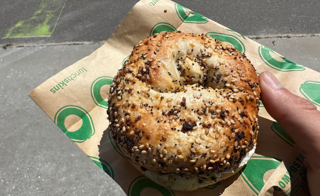 a bagel on a wrapper with everything seasoning