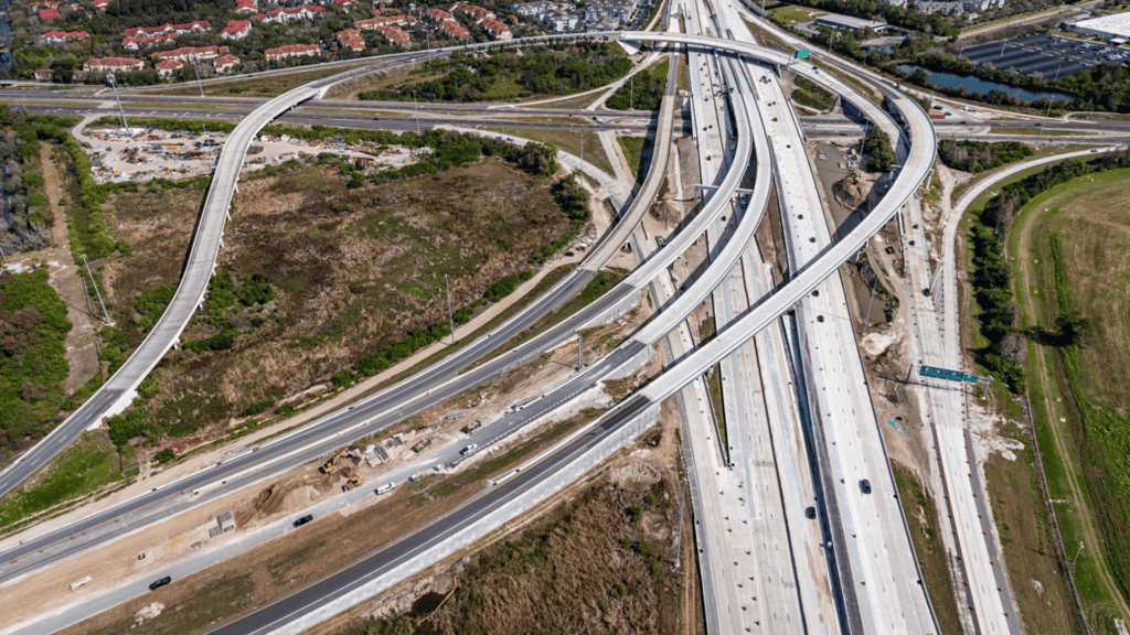 Aerial view of a highway with multiple toll roads extending off of it 