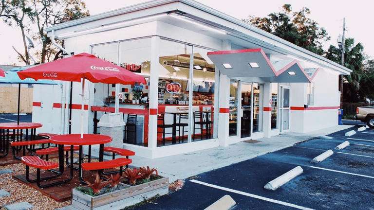 exterior of a donut shop with a doo woo style awning