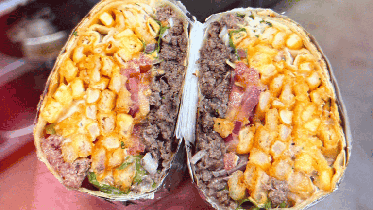 two tacos filled with meat and greens and French fries