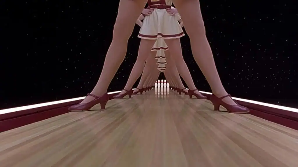 multiple sets of legs are stood over a bowling lane with an outer space backdrop 